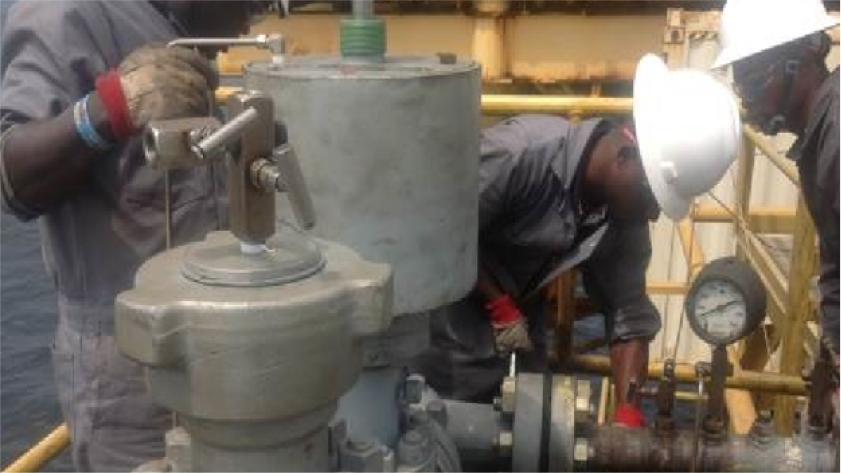 Technician servicing oilfield equipment in the field